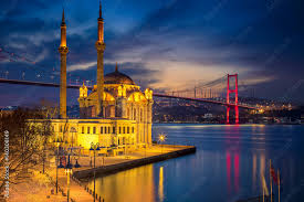 istanbul “Beautiful Istanbul skyline at night with bridge and mosque reflections on water”